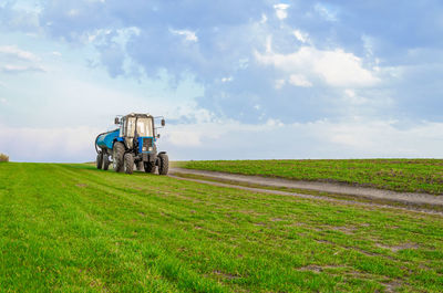 Scenic view of agricultural field against sky