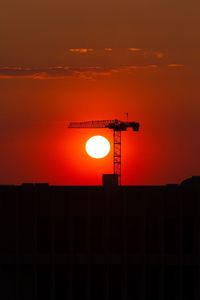 Low angle view of silhouette building against sky during sunset