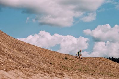 Man on mountain against sky