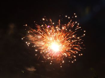 Low angle view of firework display at night