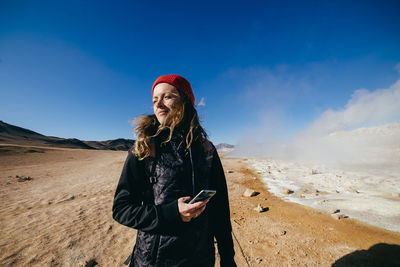 Full length of woman standing on snow covered land