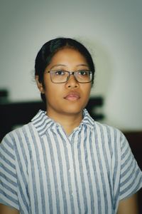 Woman wearing eyeglasses looking away at home