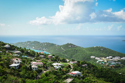 High angle view of buildings and sea against sky