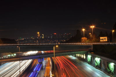 Light trails on bridge in city at night