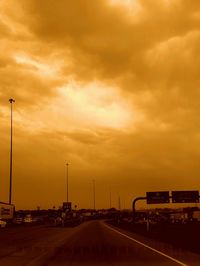 Road passing through dramatic sky