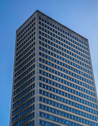 Low angle view of modern building against clear blue sky