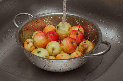 Apples in a colander in the sink