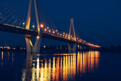 Night glowing bridge over the river