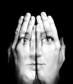 Close-up of human hand against black background