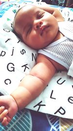 High angle view of baby boy sleeping on bed