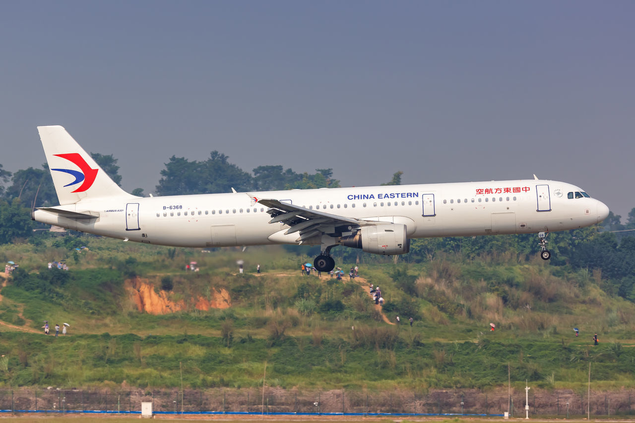 AIRPLANE FLYING ABOVE LAND