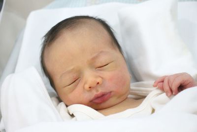 Close-up of baby sleeping on bed