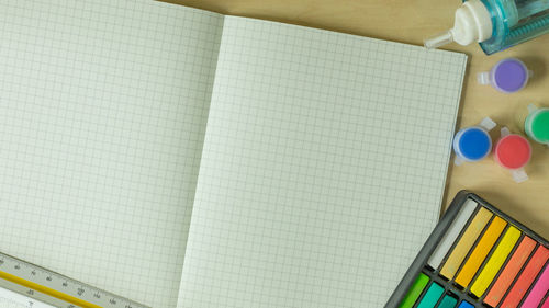 High angle view of colorful school supplies on table