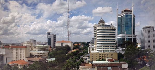 City skyline against cloudy sky