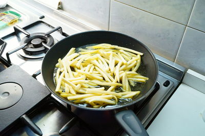 High angle view of french fries preparation in kitchen