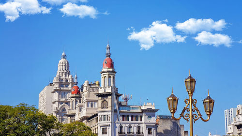 Low angle view of buildings against blue sky