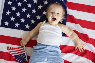 Portrait of girl holding american flag