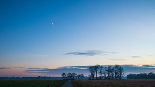 Scenic view of field against sky during sunset