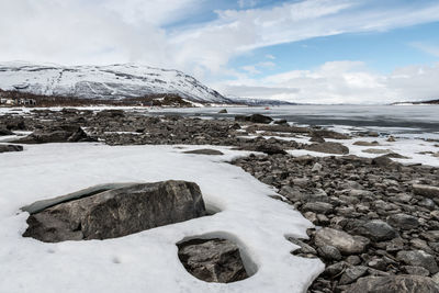 Scenic view of frozen lake against sky