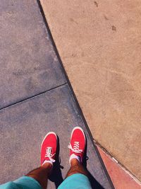 Low section of man standing on footpath