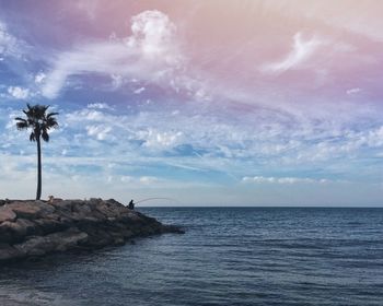 Scenic view of sea against cloudy sky