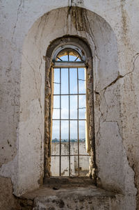 Close-up of crumbling arch with old window at portuguese colonial fort in lobito, angola