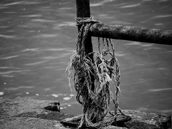 Close-up of rope tied to fishing net in sea