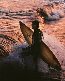 Side view of woman standing in sea
