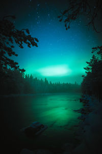 Scenic view of lake against sky at night