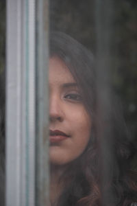 Close-up portrait of young woman looking away
