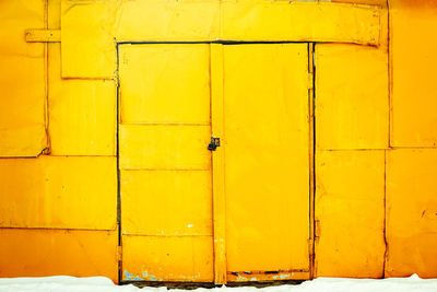 Close-up of yellow closed door