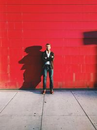 Young woman standing on wall