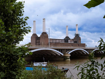 Arch bridge over river against sky