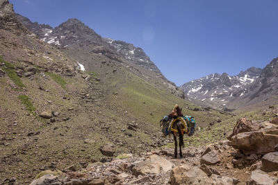 People on mountain against sky