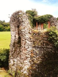 Stone wall of old building against sky