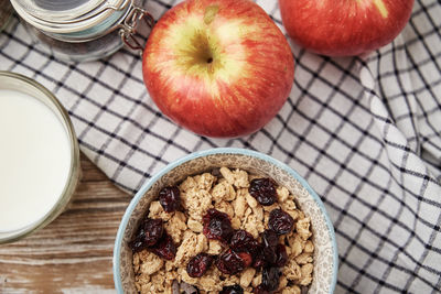 Morning breakfast with granola on wooden background, top view