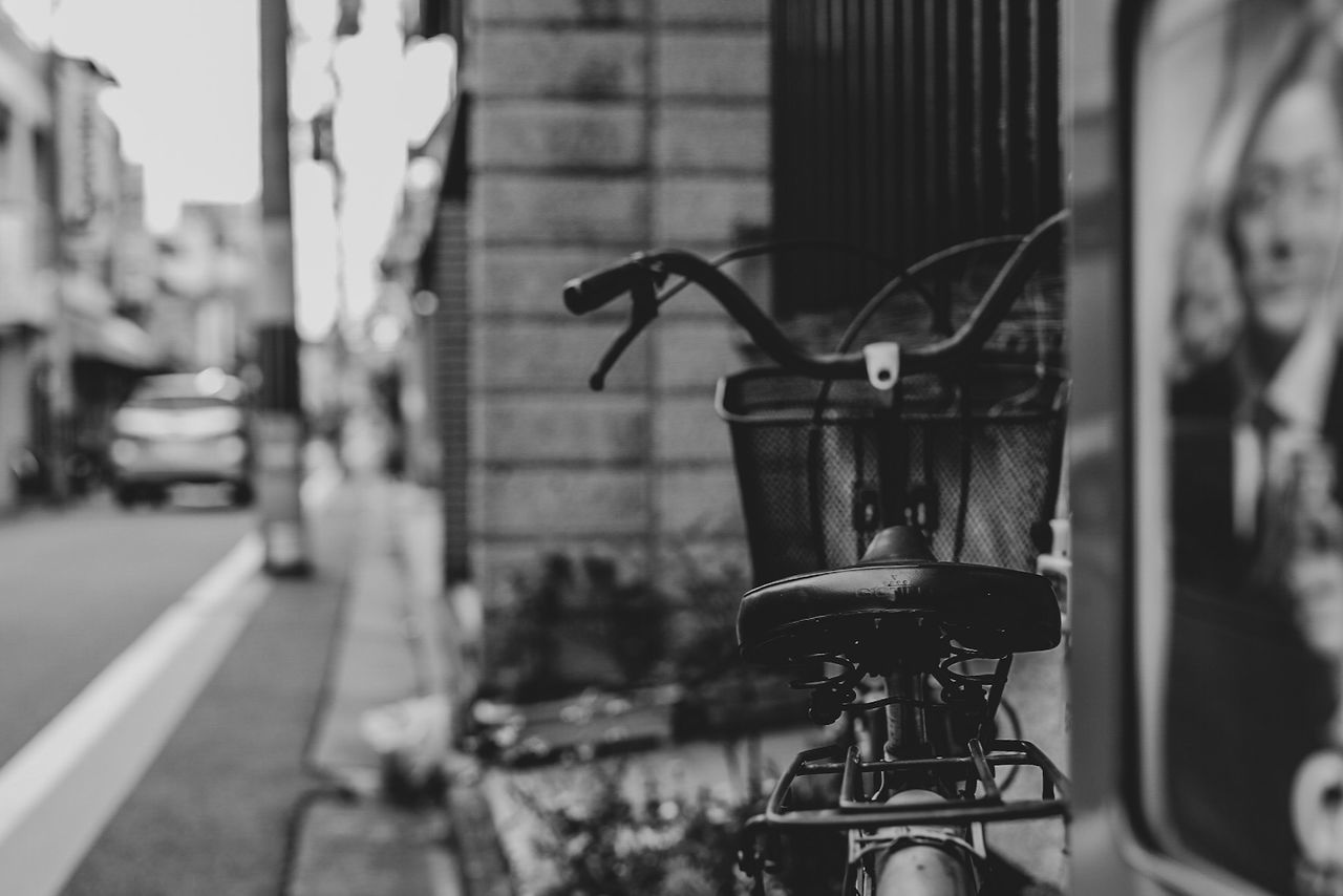 focus on foreground, transportation, bicycle, mode of transportation, land vehicle, city, street, architecture, close-up, no people, day, metal, building exterior, stationary, built structure, outdoors, nature, parking, selective focus