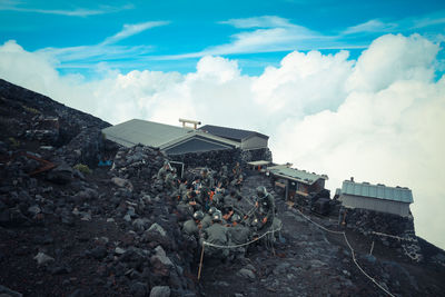High angle view of army soldiers on mountain of against sky