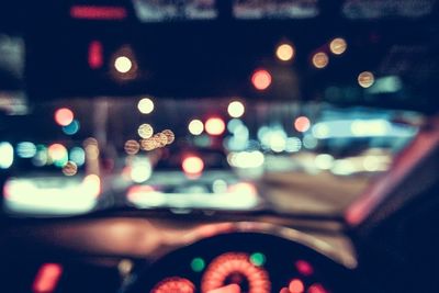 Defocused image of illuminated lights seen from car windshield