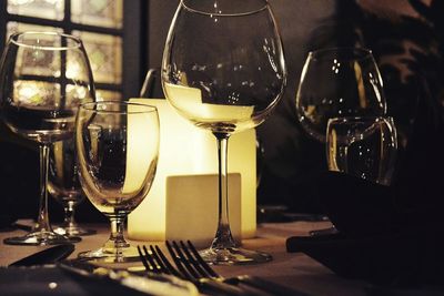 Close-up of wine glasses on table