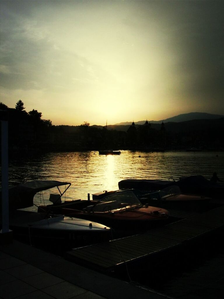 water, sunset, nautical vessel, sky, silhouette, boat, transportation, moored, mode of transport, lake, river, reflection, tranquil scene, scenics, tranquility, nature, dusk, harbor, beauty in nature, no people