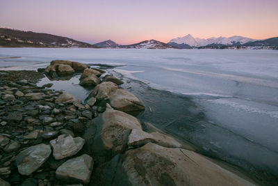 Mountain frozen lake in abruzzo at dusk, italy