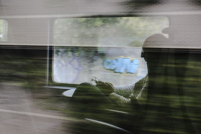 Reflection of man on glass window