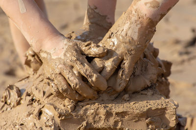 Cropped hands of people in clay