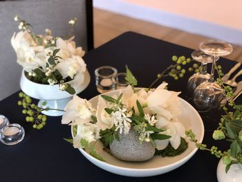 High angle view of white roses in vase on table