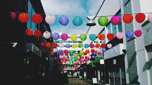 Low angle view of colorful lanterns hanging against sky