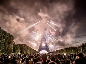 Low angle view of people at fireworks at eiffel tower in paris 