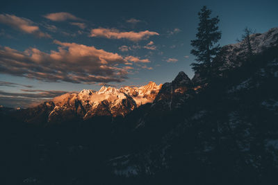 Scenic view of snowcapped mountains against sky at sunset