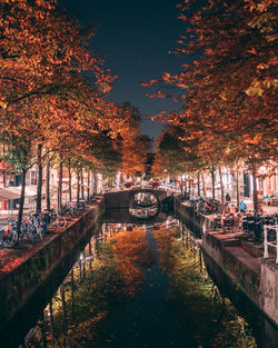 Bridge over canal in city during autumn