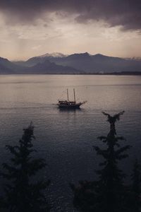 High angle view of silhouette boat on sea against sky during sunset